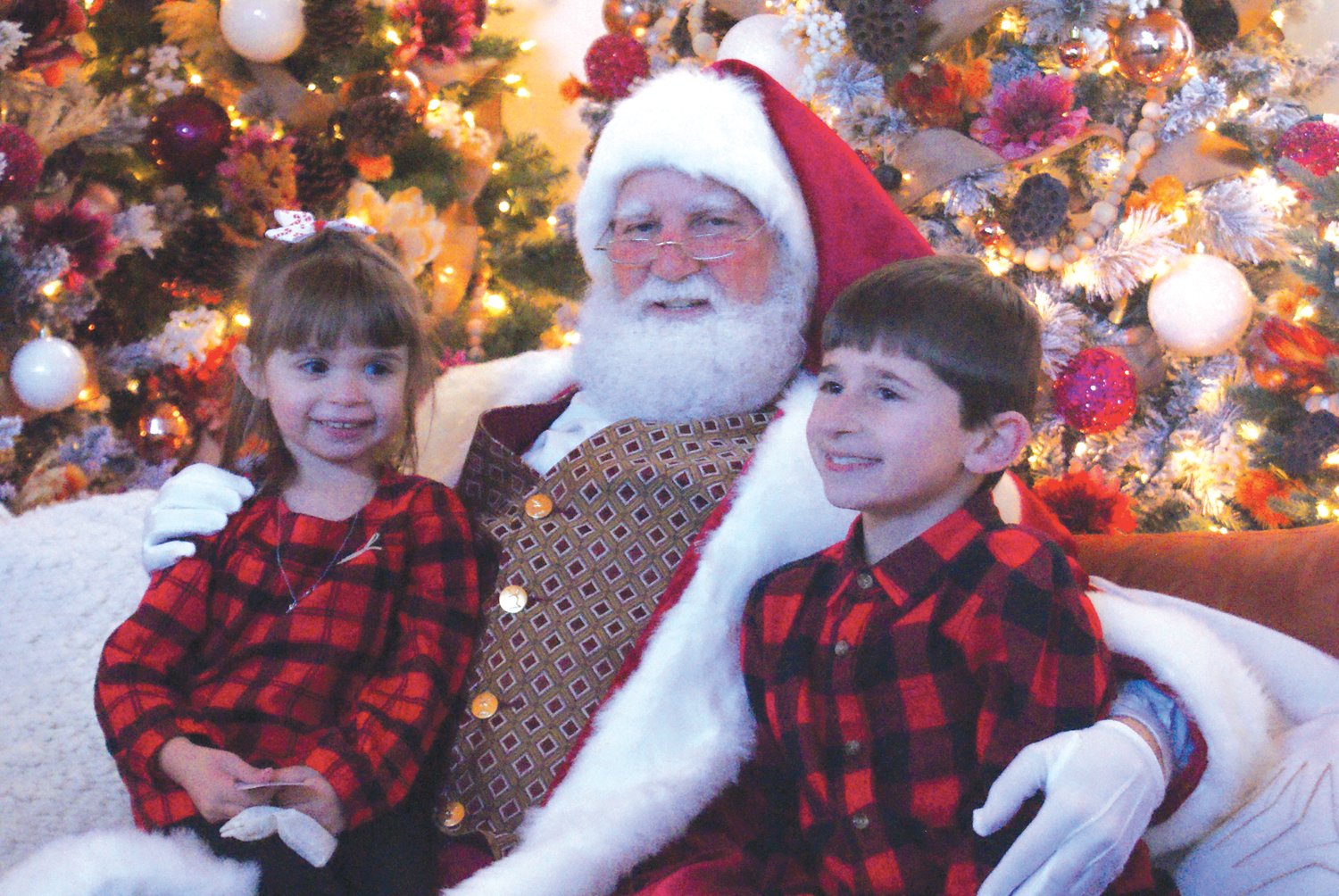 WAITING FOR THEIR PICTURE: Siblings Ella, 4, and Gabriel Romano, 8, were amongst the many children who waited for a picture with Santa at Garden City Center.